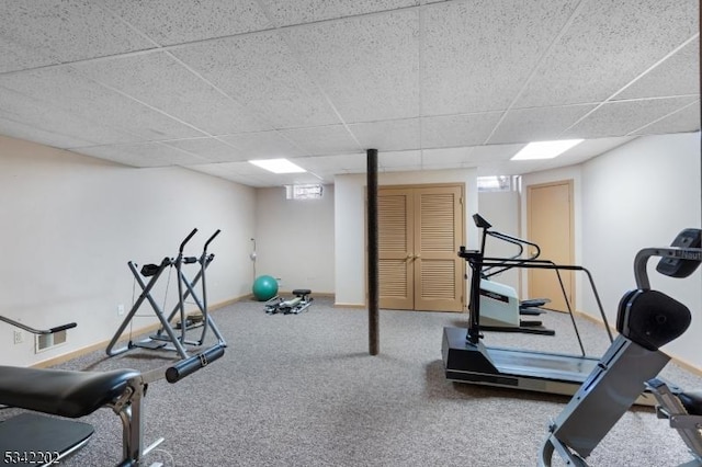 workout room with baseboards and a drop ceiling