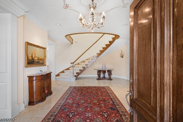 entrance foyer with light tile patterned flooring, crown molding, baseboards, stairs, and an inviting chandelier