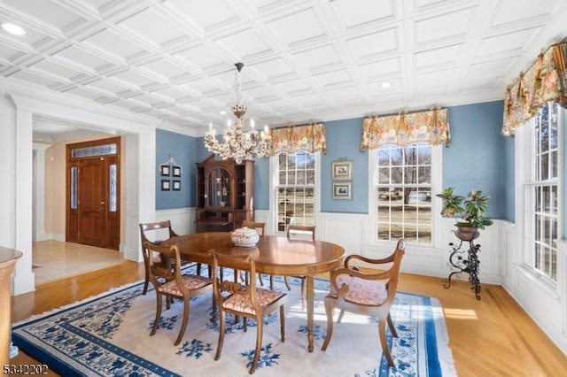 dining room with an ornate ceiling, wainscoting, and wood finished floors