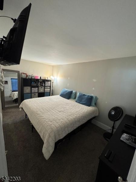 carpeted bedroom featuring baseboards