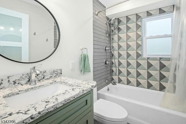 bathroom with washtub / shower combination, vanity, and toilet