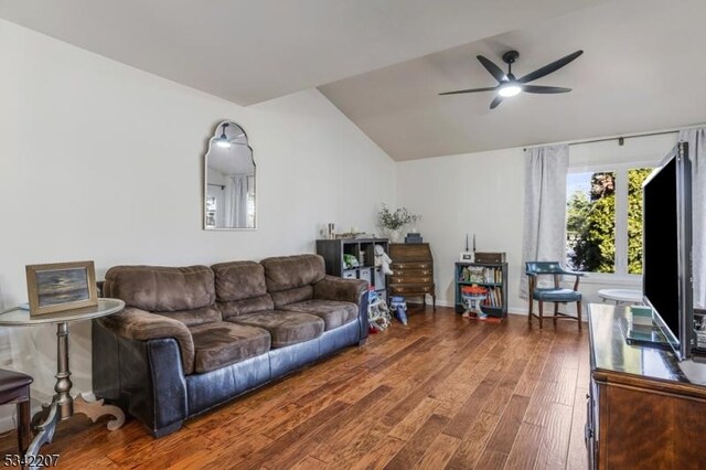 living room featuring wood finished floors, a ceiling fan, and vaulted ceiling