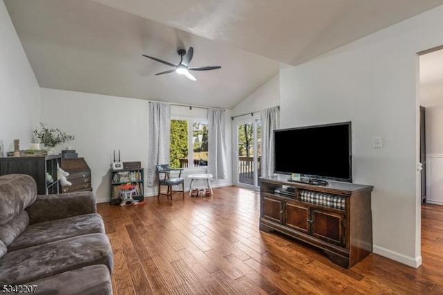 living room with a ceiling fan, lofted ceiling, wood finished floors, and baseboards