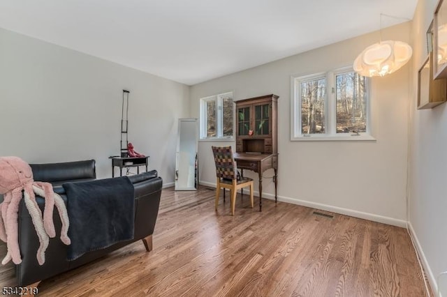 sitting room featuring visible vents, wood finished floors, and baseboards