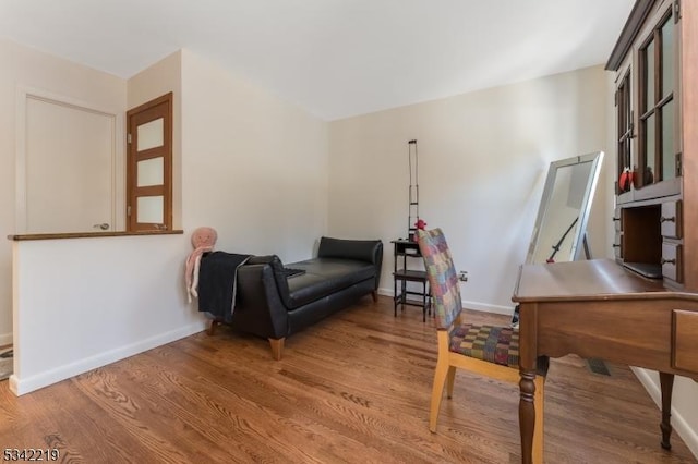 sitting room featuring baseboards and wood finished floors