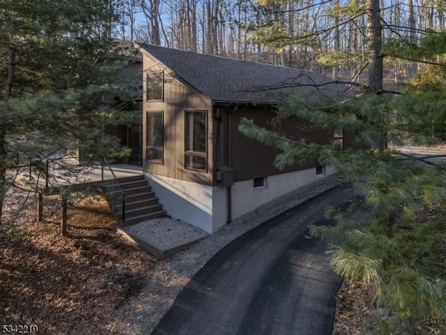 view of home's exterior with a shingled roof