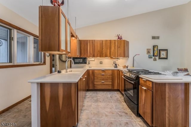 kitchen with brown cabinets, black range with gas cooktop, and a peninsula