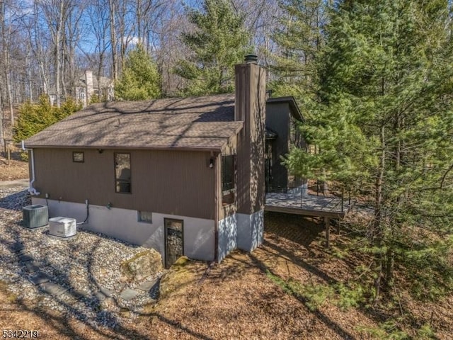 view of home's exterior featuring a chimney and a shingled roof