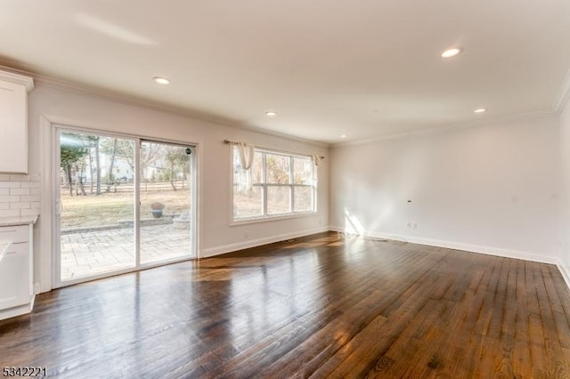 unfurnished living room with baseboards, recessed lighting, dark wood finished floors, and crown molding