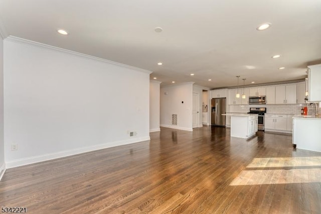 unfurnished living room featuring ornamental molding, dark wood-style flooring, and recessed lighting