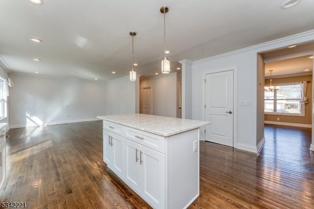 kitchen featuring white cabinets, open floor plan, ornamental molding, a center island, and dark wood-style floors