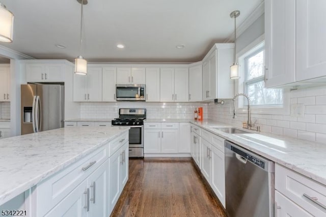 kitchen featuring appliances with stainless steel finishes, white cabinets, a sink, and dark wood-style floors