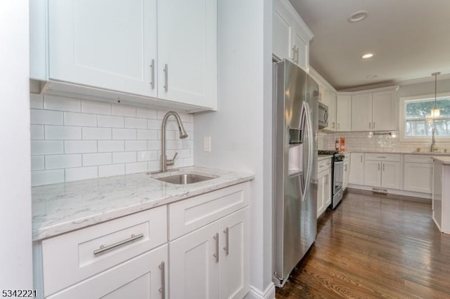 kitchen featuring white cabinets, stainless steel appliances, and a sink