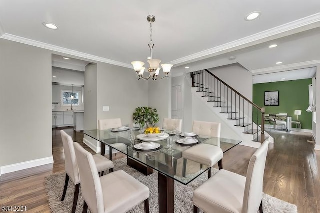 dining room with a notable chandelier, stairs, ornamental molding, and wood finished floors