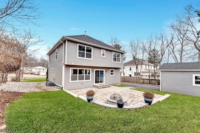 back of property with a fire pit, a lawn, a patio, fence, and cooling unit