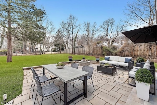 view of patio featuring outdoor dining area, an outdoor living space with a fire pit, and fence