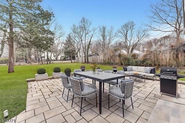 view of patio / terrace with a fire pit, outdoor dining space, grilling area, and fence