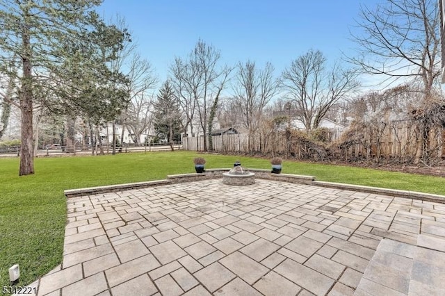 view of community with a fire pit, a patio, a yard, and fence