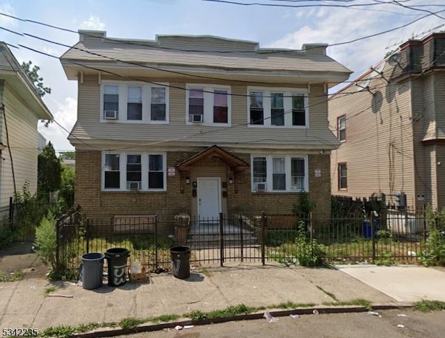 view of front of home with brick siding and a fenced front yard