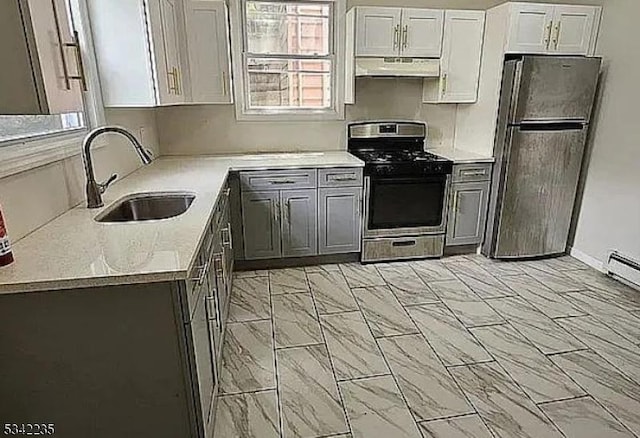 kitchen featuring stainless steel appliances, light countertops, under cabinet range hood, white cabinetry, and a sink