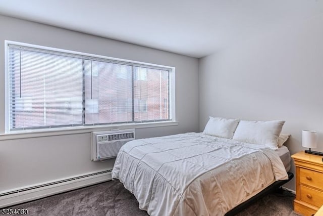 bedroom with a baseboard radiator, dark colored carpet, and a wall mounted AC