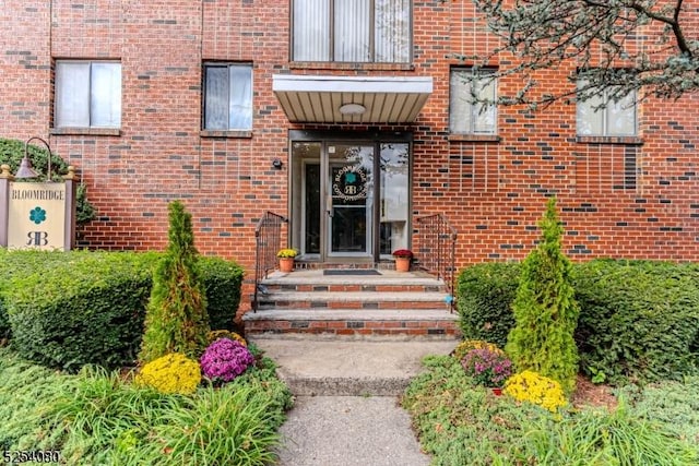 view of exterior entry with brick siding