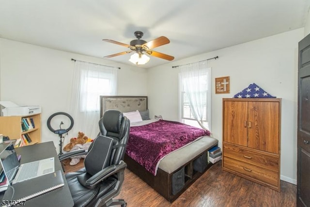 bedroom with a ceiling fan, multiple windows, and wood finished floors