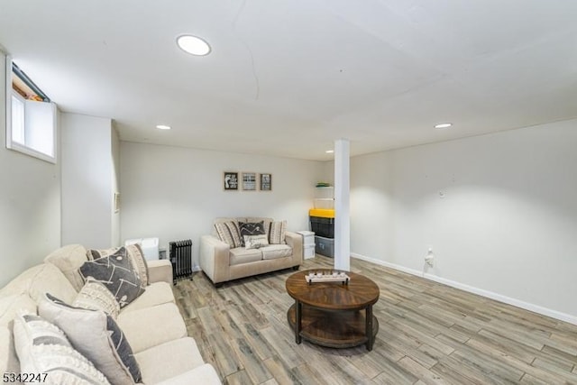 living room with recessed lighting, baseboards, and wood finished floors