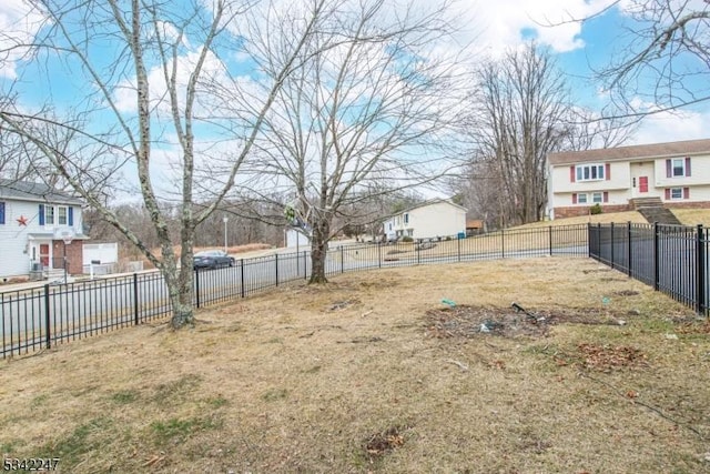 view of yard with a residential view and fence