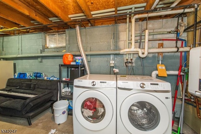 clothes washing area featuring laundry area and washer and clothes dryer