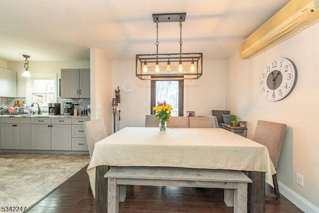 dining area with plenty of natural light, a wall unit AC, and baseboards