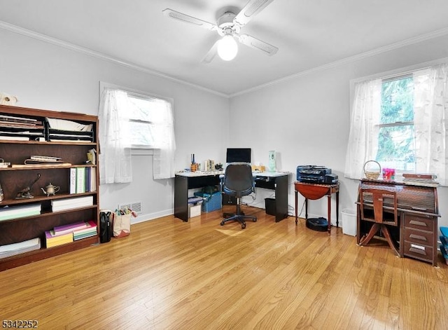 office area featuring ceiling fan, ornamental molding, wood finished floors, and a wealth of natural light