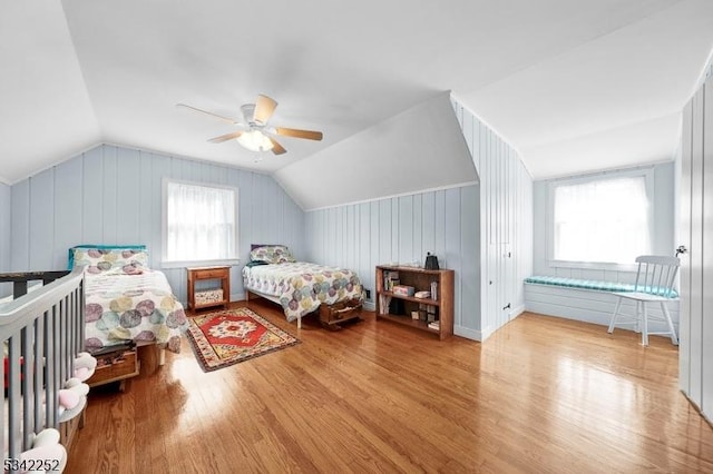 bedroom featuring ceiling fan, vaulted ceiling, and wood finished floors