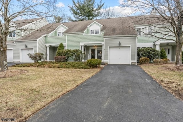 townhome / multi-family property featuring a garage and driveway