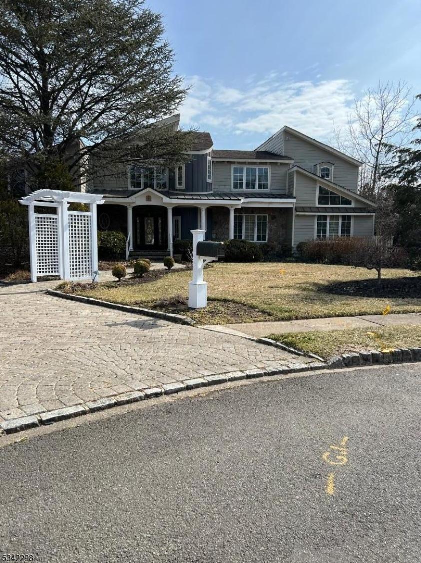 view of front of house with a standing seam roof and a front lawn