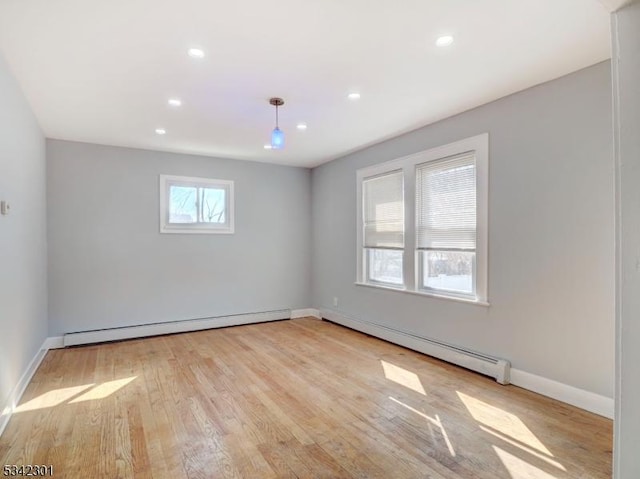 unfurnished room with recessed lighting, wood finished floors, and a baseboard radiator