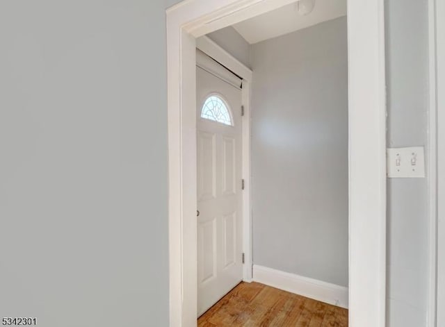 entryway featuring baseboards and light wood-type flooring