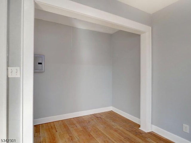 unfurnished room featuring baseboards and wood-type flooring