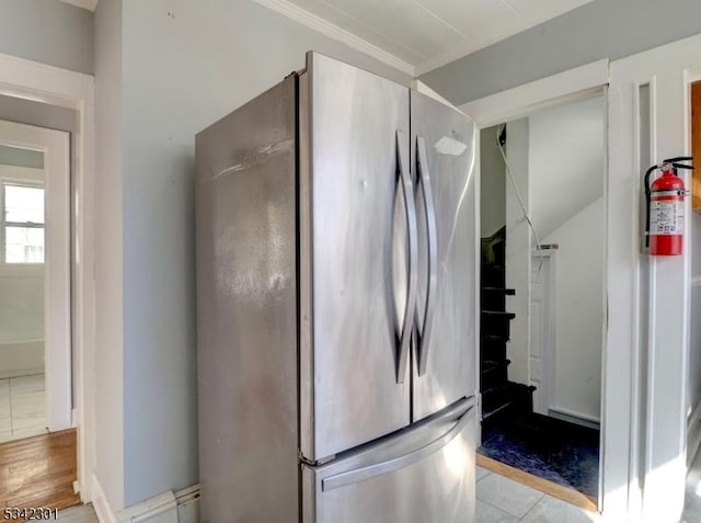 kitchen featuring crown molding and freestanding refrigerator