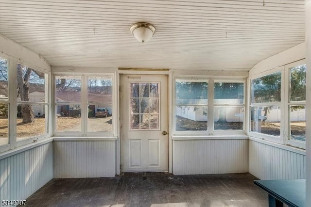 unfurnished sunroom featuring vaulted ceiling