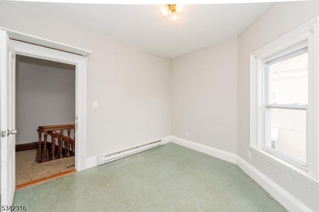 empty room featuring baseboards and a baseboard heating unit