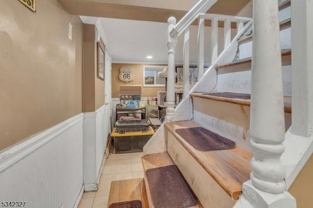 stairway with recessed lighting, tile patterned flooring, and wainscoting