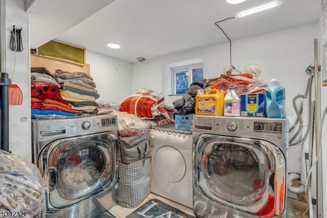 laundry room with laundry area, separate washer and dryer, and tile patterned floors