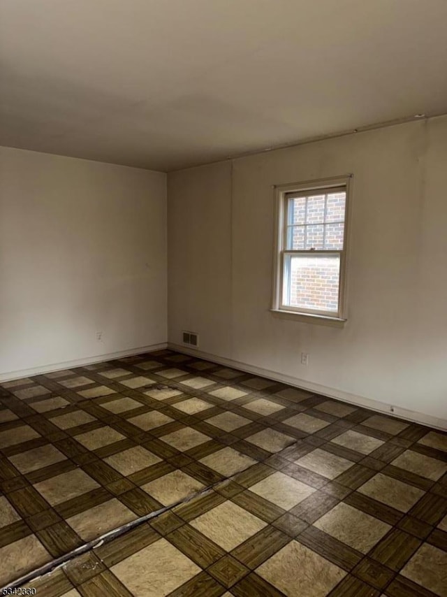 unfurnished room featuring visible vents and baseboards