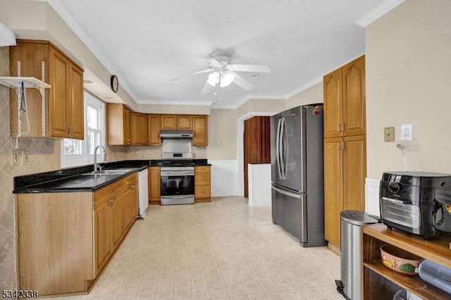 kitchen with under cabinet range hood, stainless steel appliances, a sink, tasteful backsplash, and crown molding