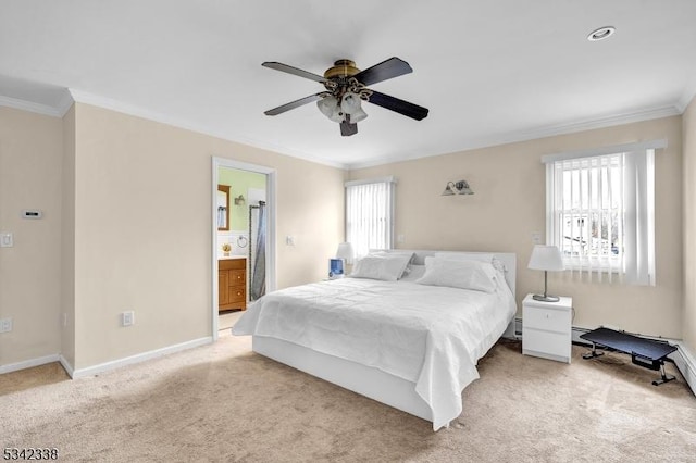 bedroom with a ceiling fan, baseboards, carpet, ensuite bath, and crown molding