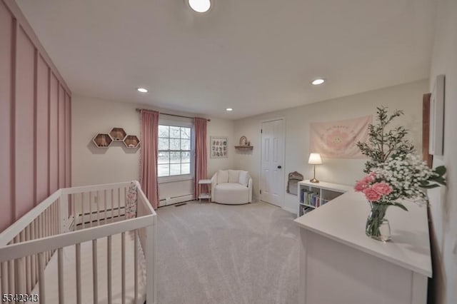 bedroom featuring recessed lighting, light carpet, a nursery area, and baseboard heating