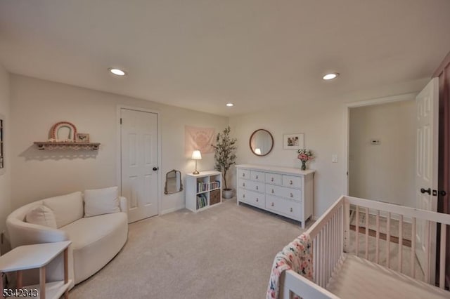 bedroom with a crib, carpet, and recessed lighting