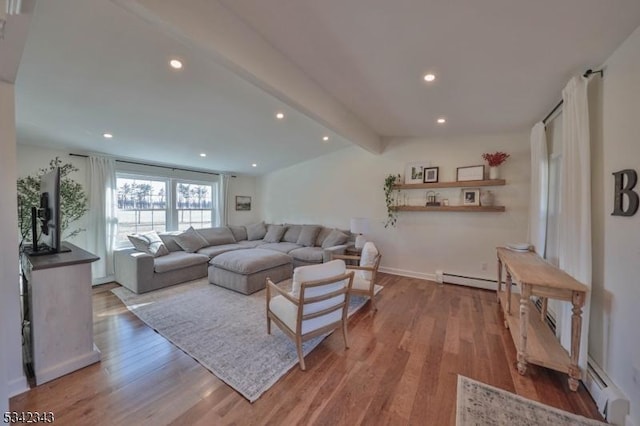 living area featuring vaulted ceiling with beams, a baseboard heating unit, wood finished floors, and recessed lighting