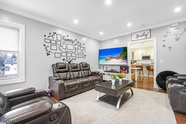 living room with recessed lighting, wood finished floors, and ornamental molding